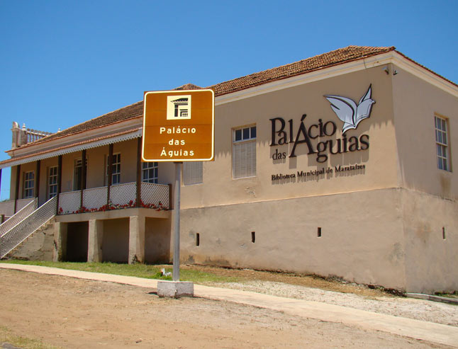 uma placa de rua em frente a um prédio escrito "palácio das águias"