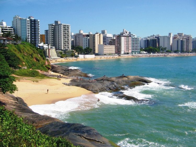 uma vista de uma praia com uma cidade ao fundo